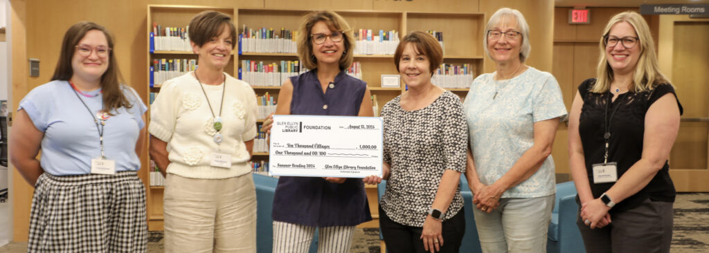 The Glen Ellyn Library Foundation presents a check to Ten Thousand Villages