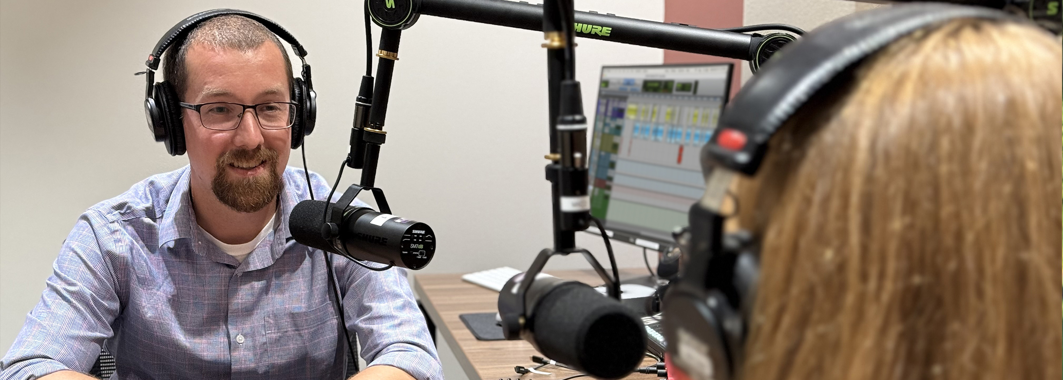 two friends recording a podcast in The Studio
